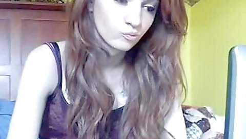 Hot amateur girl in a sexy pose on the bed with her lips moving